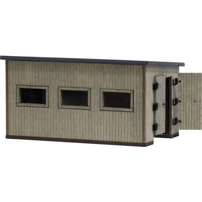 A small rectangular wooden outbuilding with a flat roof and three rectangular windows on the front, with a door open on the side.