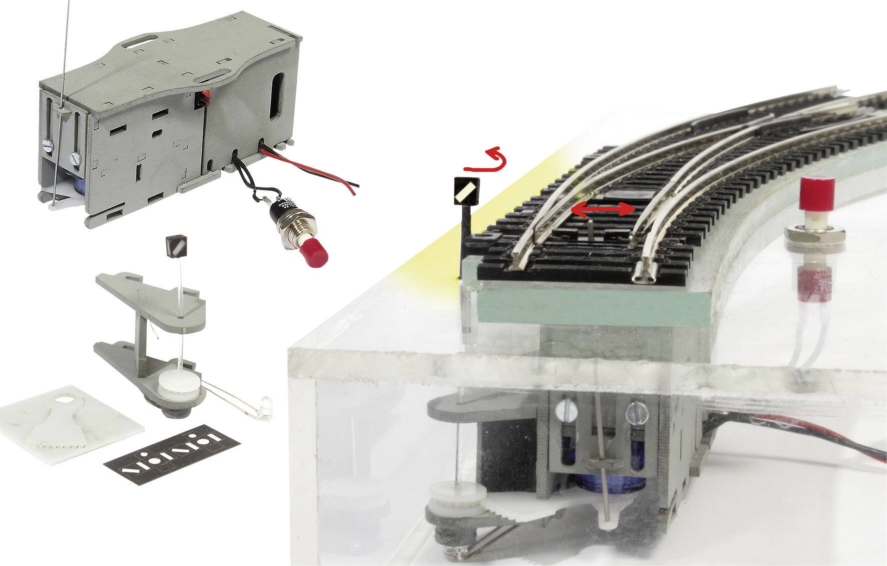 'Model of an electrical railway circuit with a servo connection module, switches, and a curved section with points.'