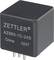 Black, cube-shaped relay with inscription 'ZETTLER AZ983-1C-24D China 02X7'. Has four metal pins on the underside.