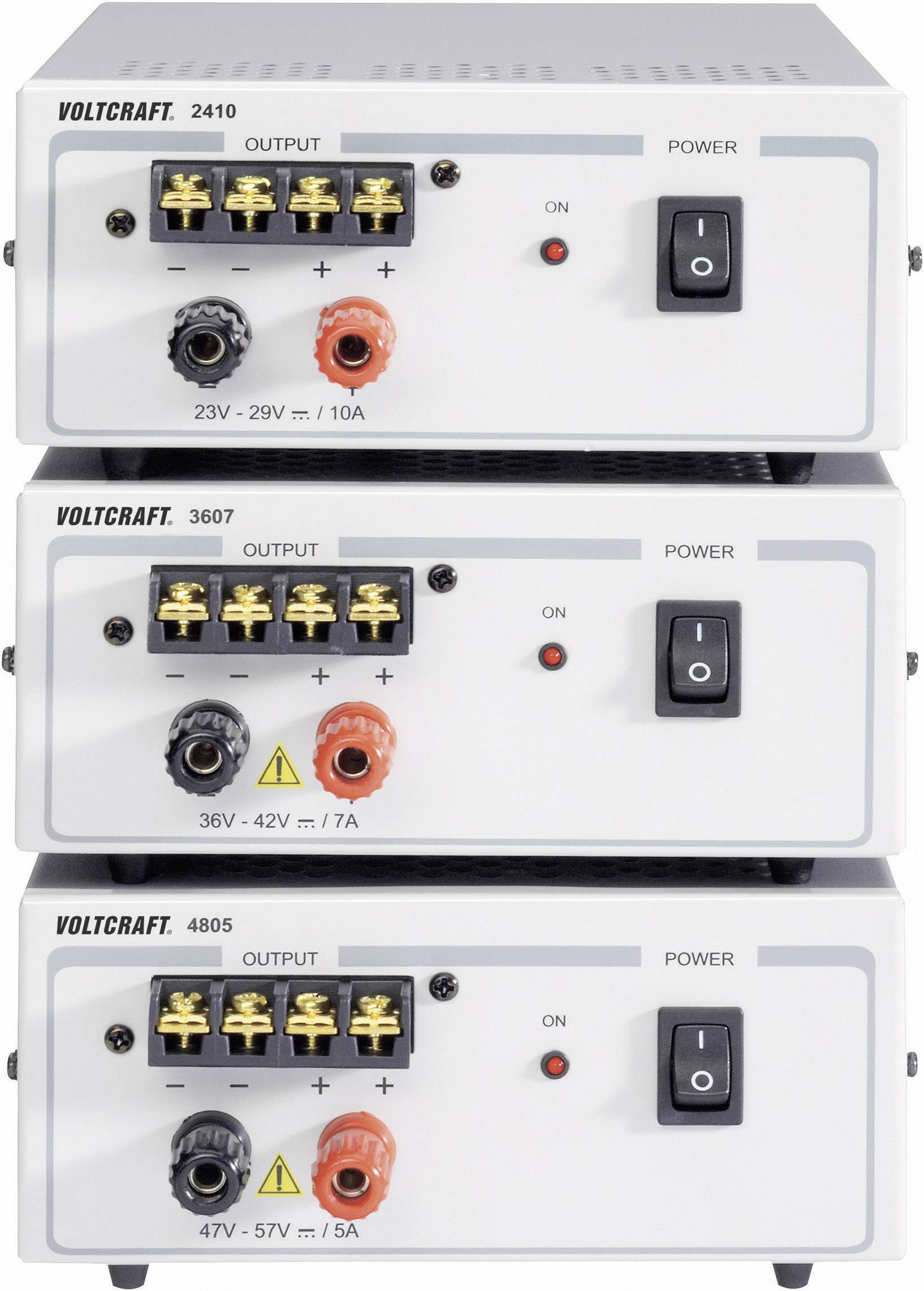 'Three stacked Voltcraft power supplies, models 2410, 3607 and 4805, with different output voltages and current ratings. Each device has switches and connections.'