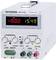 A white DC power supply with a digital display shows '+000.0' for current and '15.49' for voltage. It has controls for current and voltage.