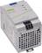 A switch-mode power supply with ventilation slots and technical specifications on the front, including voltage and current rating.