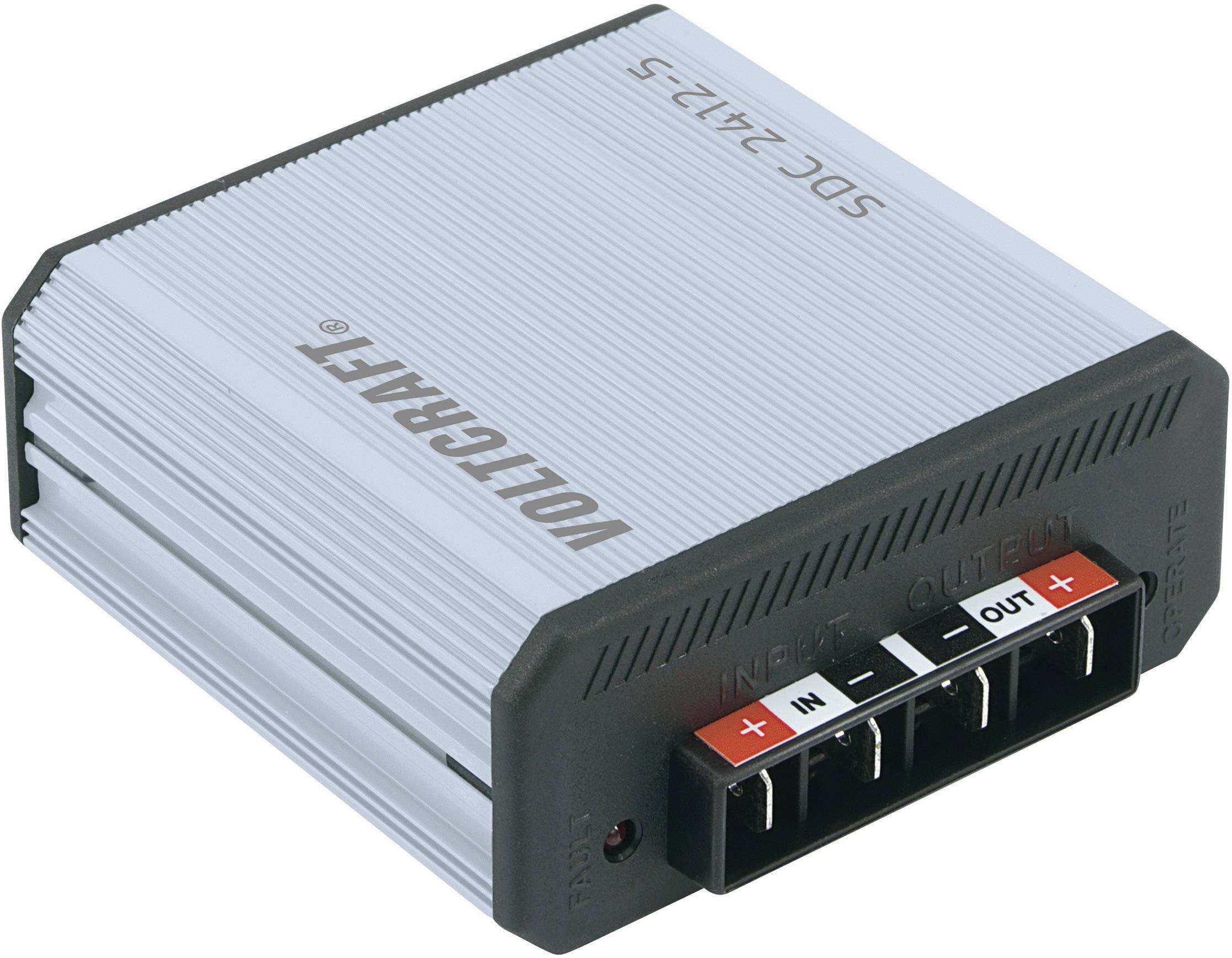 Pictured is a grey Voltcraft power supply model SDC-2412-5 with black connectors for 'IN' and 'OUT'.