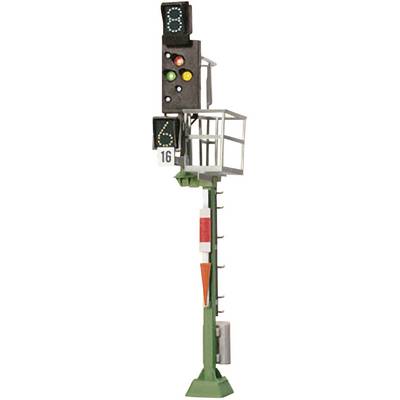 A railway signal with four lights: green, yellow, red and a flashing orange light. A metal sign displays the number '16'.