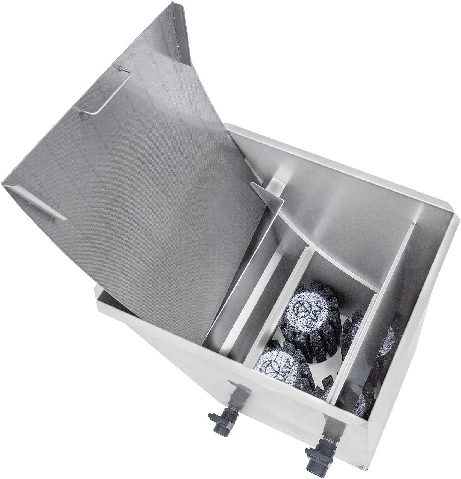 'Metal container with an open lid, containing several round brushes with handles. Likely used for cleaning or sorting.'