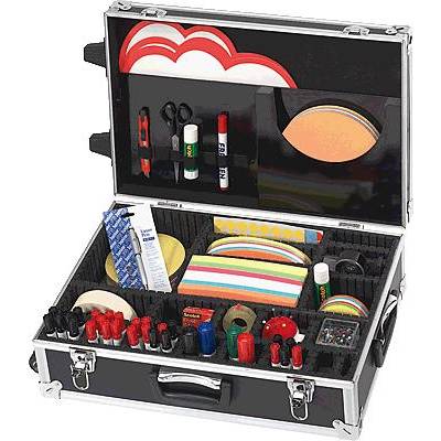 An open black suitcase with various office supplies, including glue, scissors, colourful notepads and pens, neatly arranged.