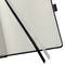 An open notebook with a black cover, two bookmark ribbons in black and white, lying on page 151, without any text.