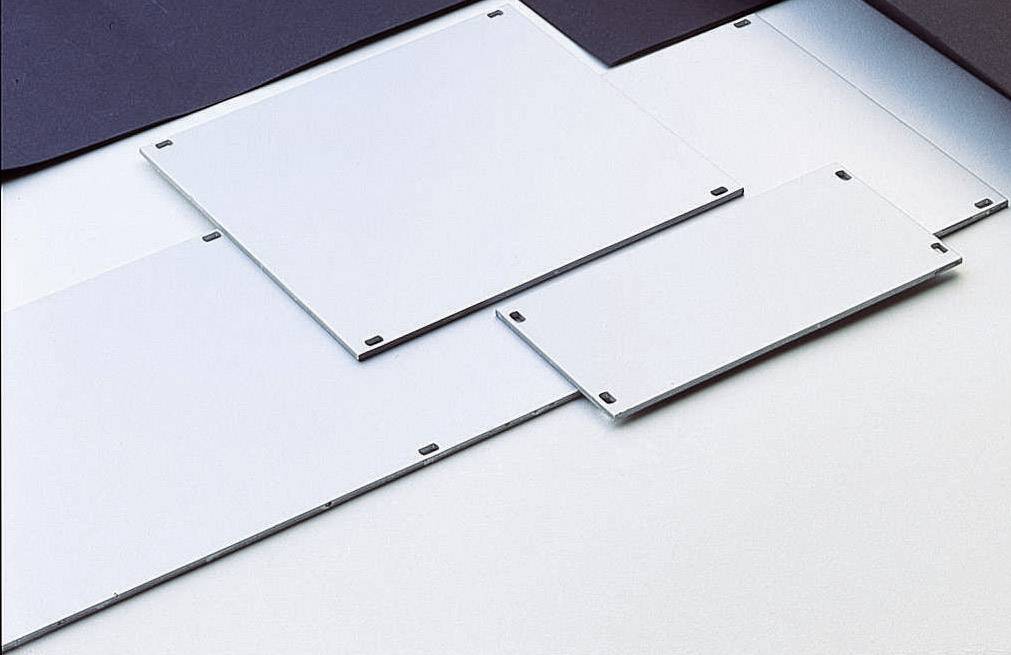 Four white aluminium plates, rectangular and of varying sizes, are lying on a table. Some are slightly stacked on top of each other.