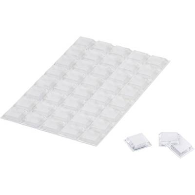 Transparent self-adhesive rubber feet on a sheet, with some detached beside it. Perfect for preventing furniture from slipping.