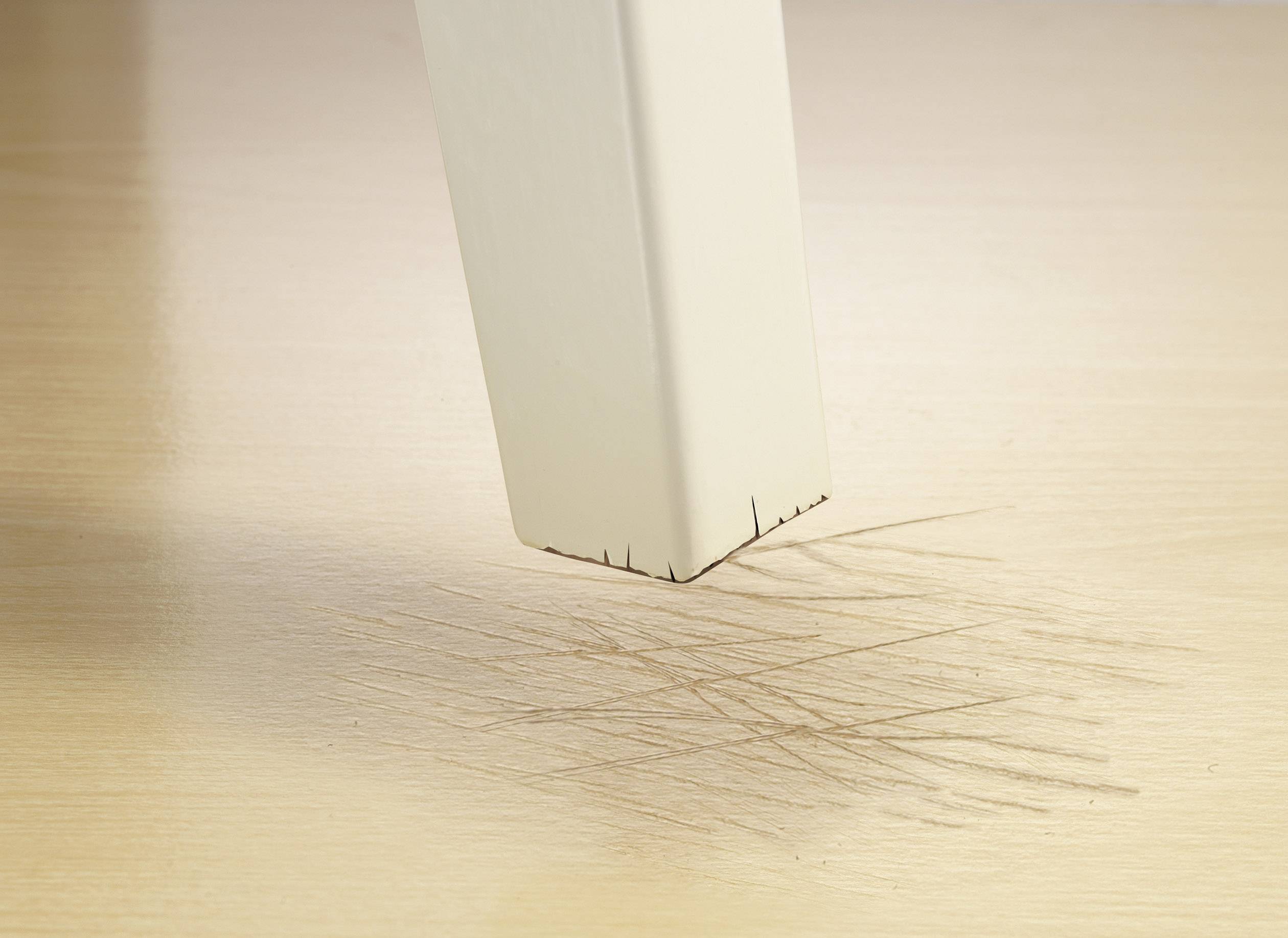 A table leg is scratching a wooden floor.