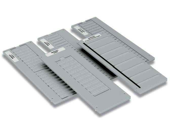 Four grey plastic plates with overlapping slots, labelled 'WAGO'. They are flat and rectangular in shape.