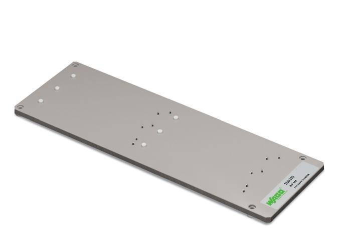 Metal plate with green company lettering in the corner, various mounting holes evenly distributed, rectangular shape.