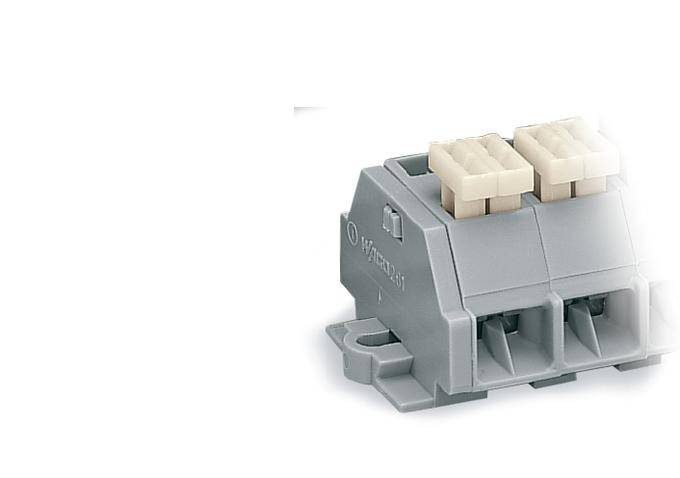 A grey electrical plug or terminal block with two white connections on the top surface, used for wiring purposes.
