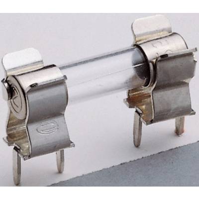 'Close-up of a glass fuse with metal caps, lying on a grey surface, with two protruding terminals.'