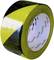 Yellow and black safety warning tape used for marking hazard zones on construction sites and storage areas.