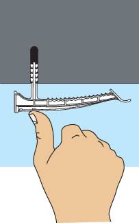 A hand presses a curved plastic strip underneath a table.