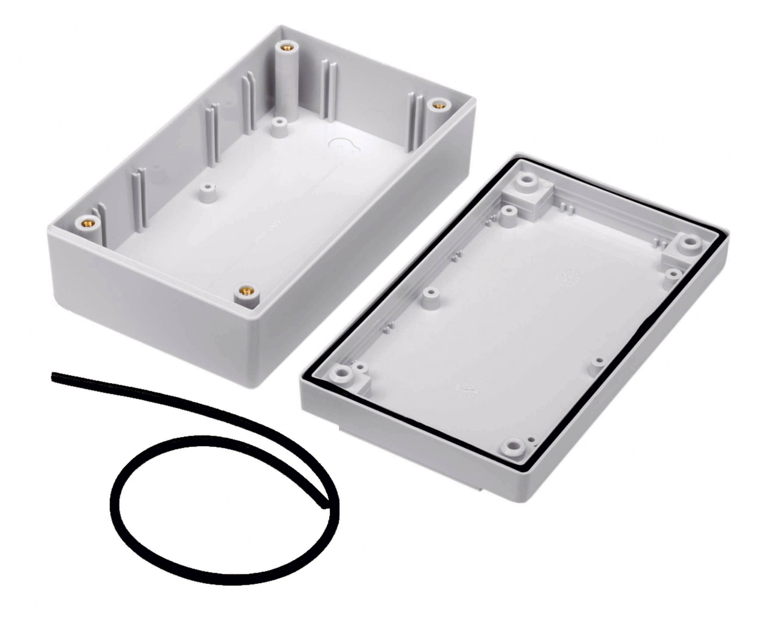 A white plastic enclosure with its lid removed, with a black sealing band beside it. Suitable for electronic components.