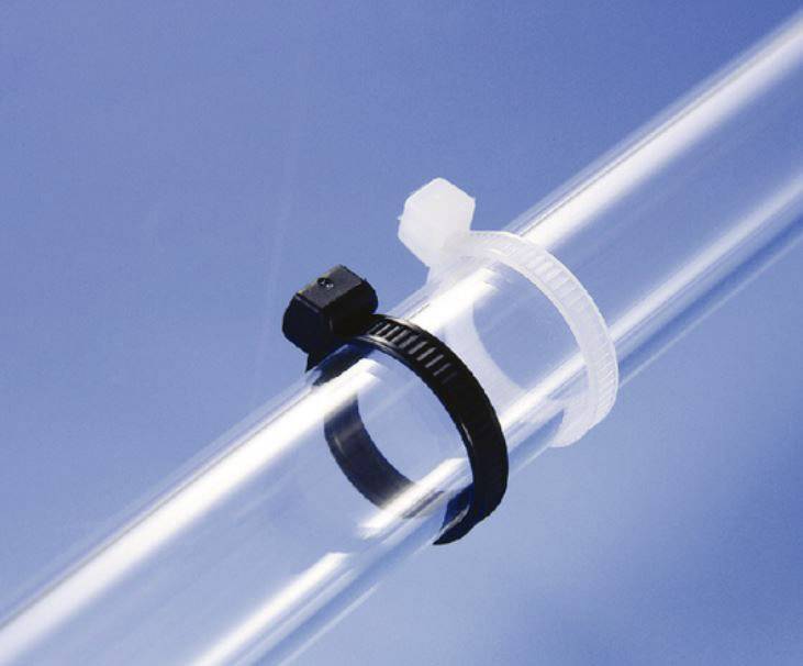 A transparent plastic tube secured with two cable ties, one black and one white, against a blue background.