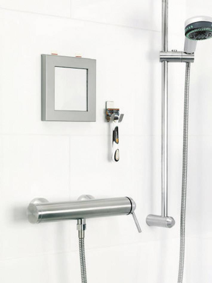 A modern bathroom with a chrome shower fitting and a square mirror mounted on the white tiled wall.
