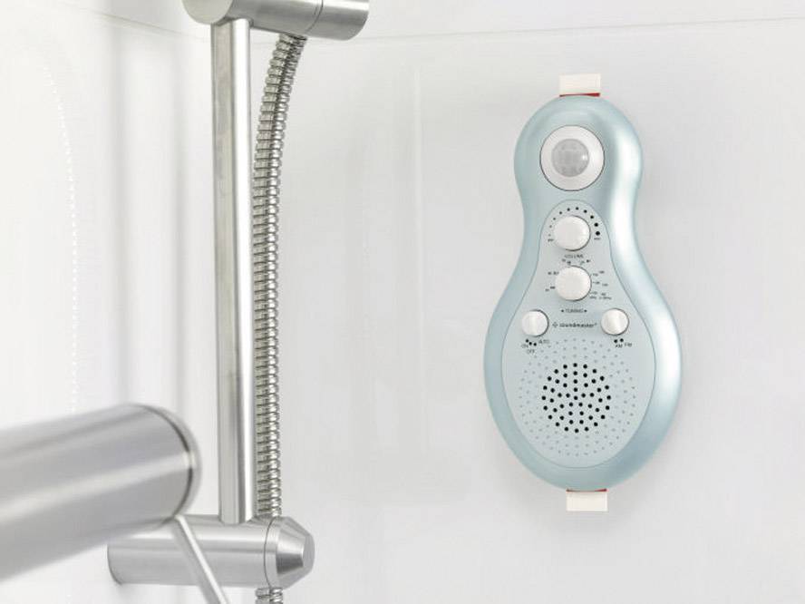 A blue shower radio is mounted on a white bathroom wall next to a shower head. It has three controls and a speaker.