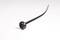 A black cable tie is lying on a white background, with the fastening end visible in the foreground.