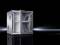 A silver, empty server rack with an open door stands on a glossy black background.