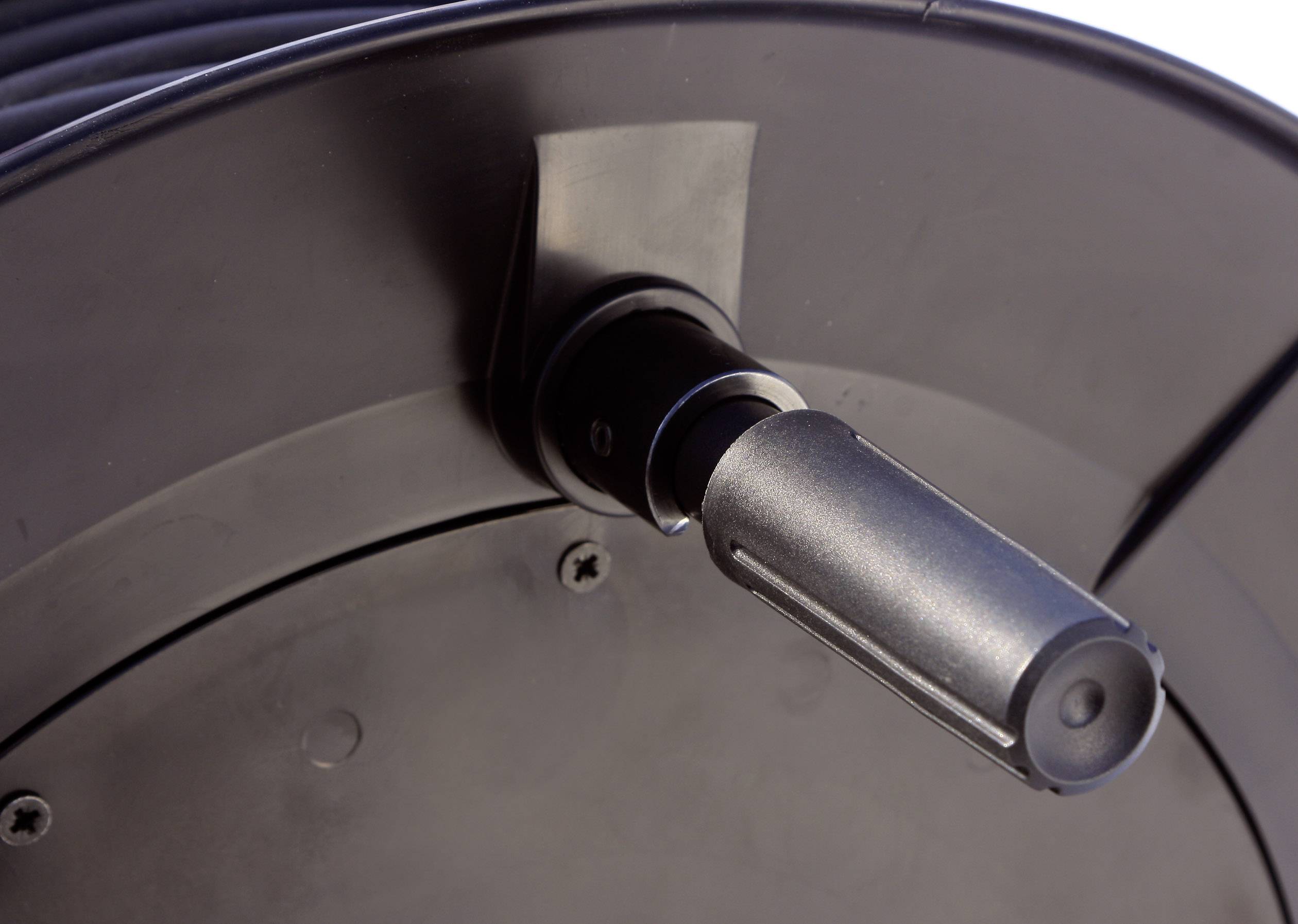 Close-up of a black cable reel with a handle for easy winding and transporting of cables.