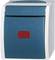 A blue electric wall switch with a rectangular red indicator on the front, surrounded by a grey frame.