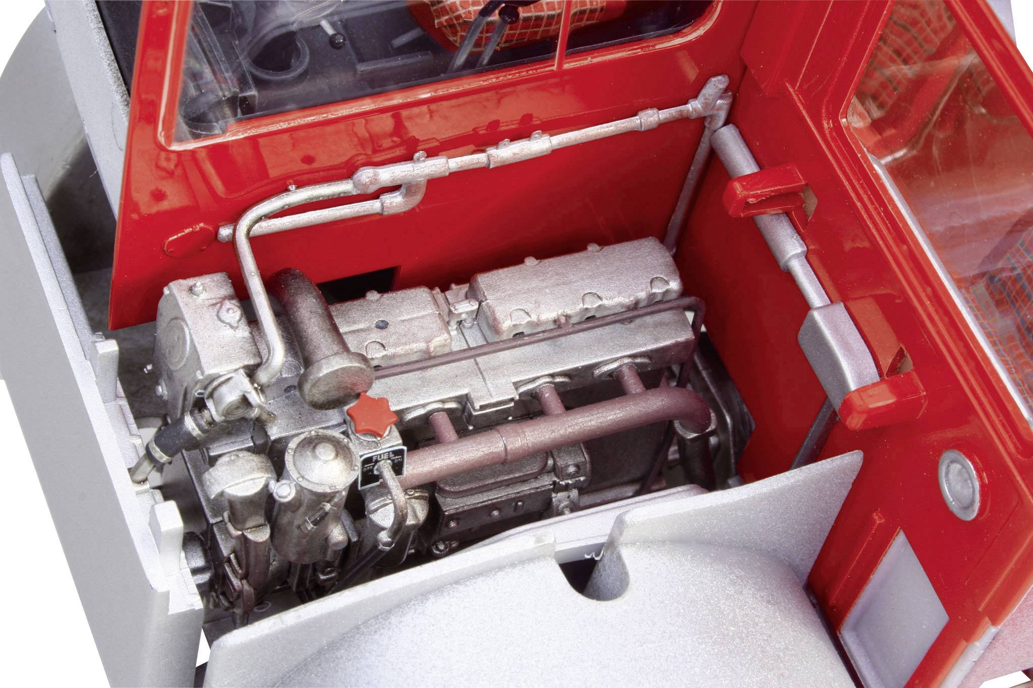 Engine bay of a vehicle with a detailed view of the engine and red bodywork. Components and pipes are clearly visible.