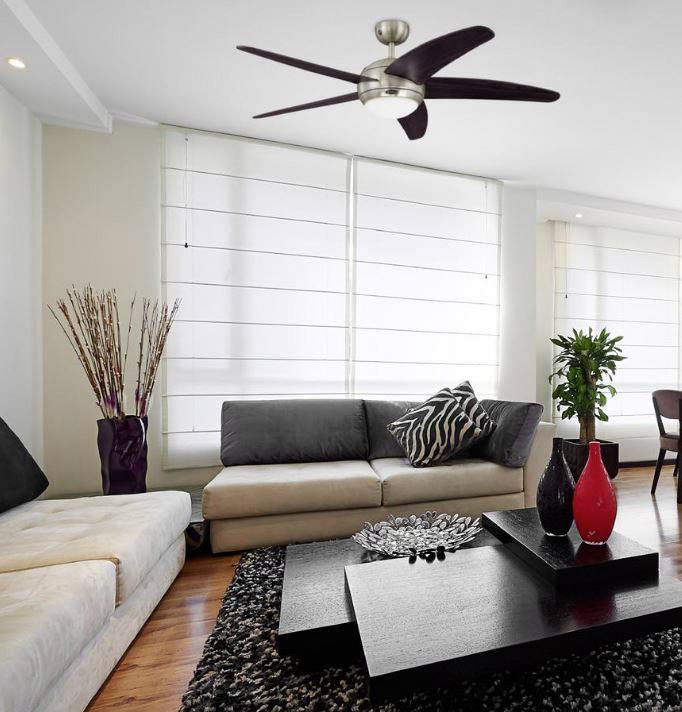 Living room with modern design: Two sofas in front of large, open blinds, a dark coffee table with decorative items and plants.