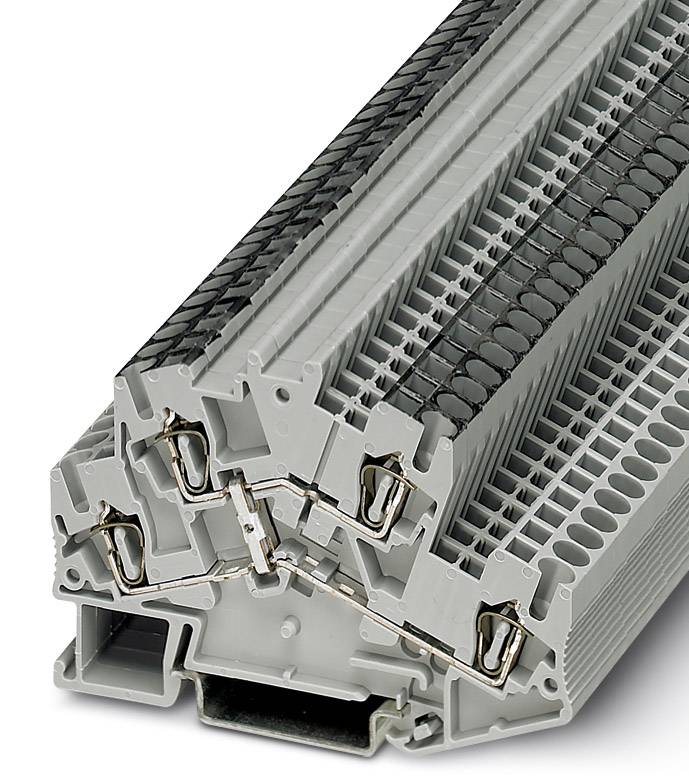 Stack of grey, triangular terminal blocks with metallic contacts used for wiring and electrical engineering.