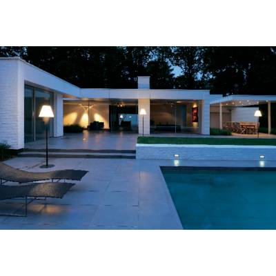 Modern Villa at Night, with illuminated courtyard, pool in the foreground and large glass windows that make the interior glow.
