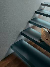 Suspended metal staircase with wooden treads and integrated lighting; decorative shopping bag on the steps; modern style.