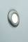 A black object against a mint green background. The object has a round, smooth surface with a dark circle in its centre.
