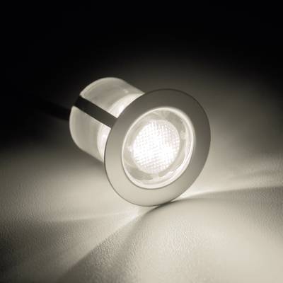 A bright LED spotlight shining on a surface and casting a light beam.