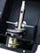 Metallic mechanical assembly with an axle, screws and cables housed within an enclosure, likely part of a technical or industrial machine.