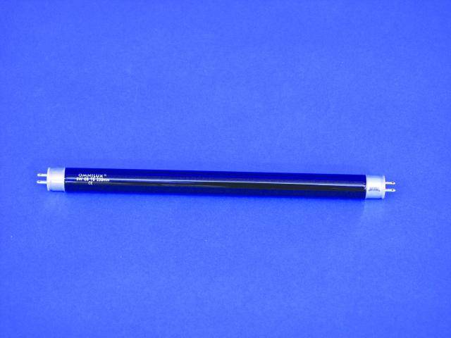 A UV fluorescent tube lies horizontally on a blue background. It has metal ends and a dark glass surface.