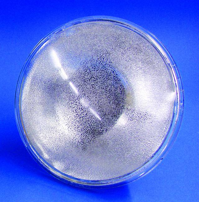 A clear glass bowl on a blue background, with condensation on its inner surface.