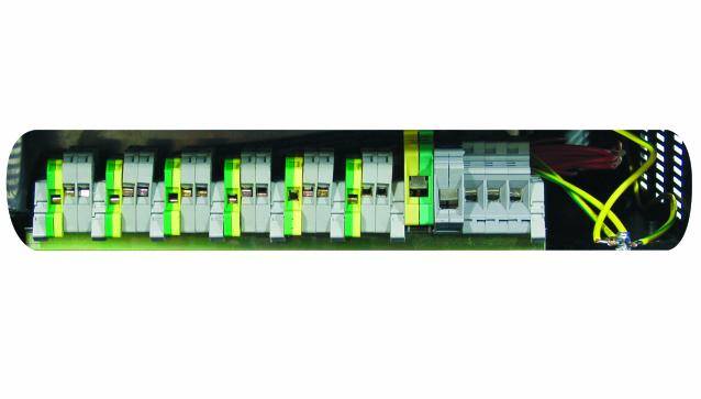 An electrical switchboard module with green-white switches and cable connections.