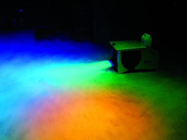 A fog machine projects colourful lights onto the floor, creating a gradient from blue to red.