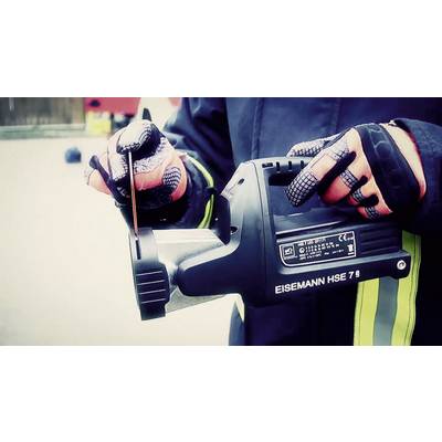 A person in protective clothing is holding an EISEMANN HSE 7 rescue saw during a rescue operation.