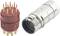 A multi-pole plug adapter in red with eleven plug contacts next to a silver round connector, both for technical connections.