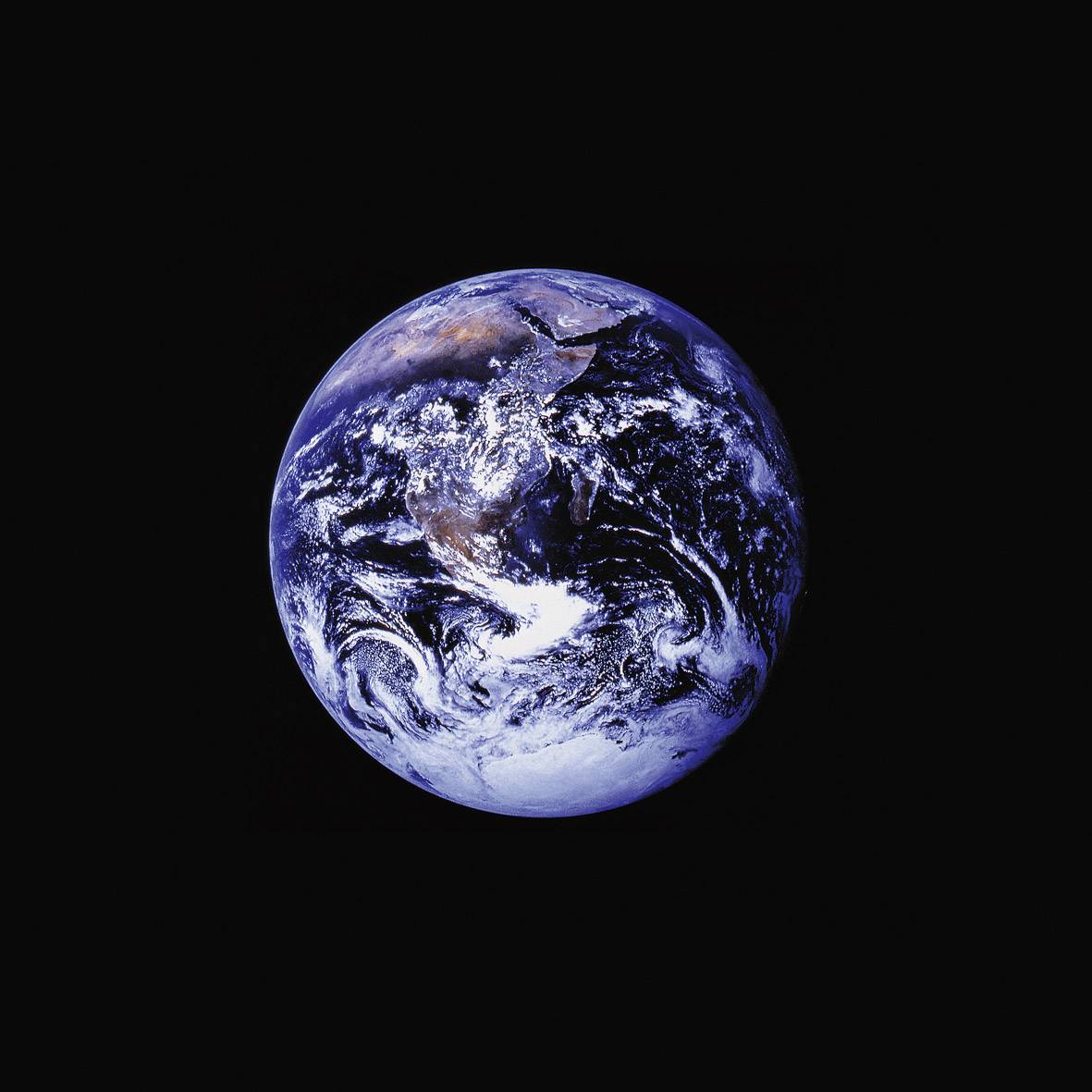 A photograph of the Earth from space, with distinct outlines of continents and clouds in vibrant shades of blue and white.