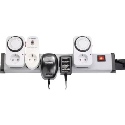 Four-way power strip. Plugged in are two timer switches, a wireless dimmer, a charger and a mains adapter.