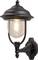 Black outdoor wall light with a round glass dome and visible light bulb, mounted on an ornate wall bracket.