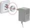 An adaptor plug is inserted into a white socket, next to a grey charger with a red arrow pointing at the adapter.