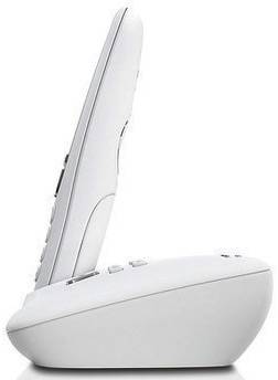 A cordless telephone in side profile. It is standing in a base station and is white in colour.