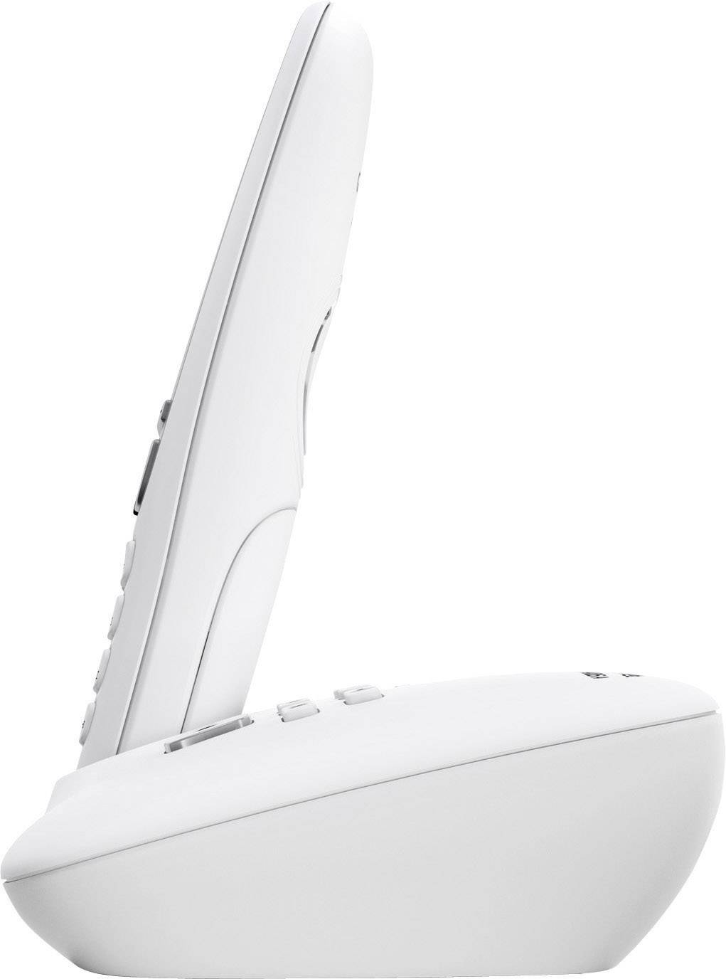 A cordless telephone in a side view, positioned on a charging station.