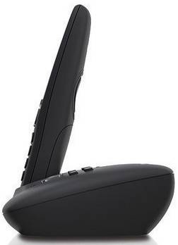 Cordless black telephone in side view, standing on charging station. Main screen and buttons are not visible.