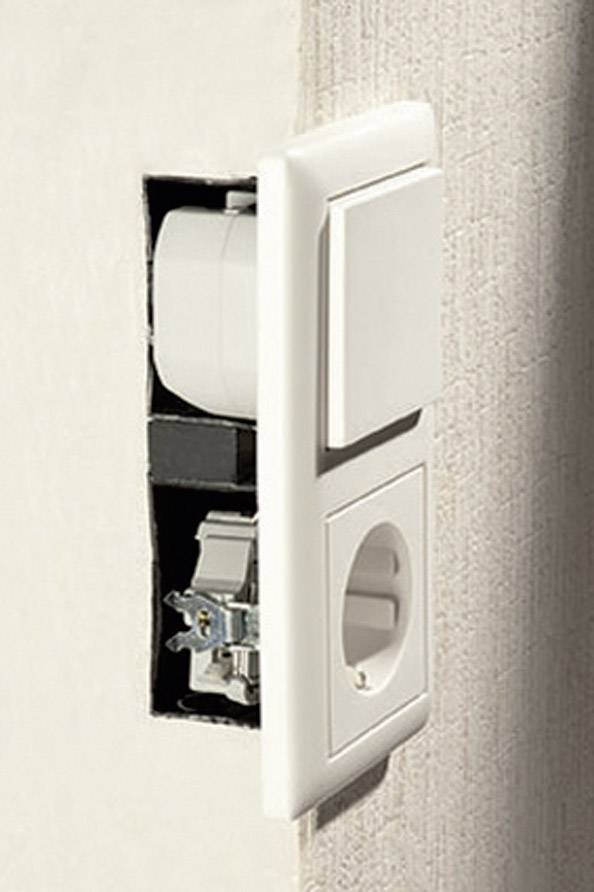 Electrical wall socket with its cover plate removed, revealing the internal wiring and connection mechanisms on a wall.